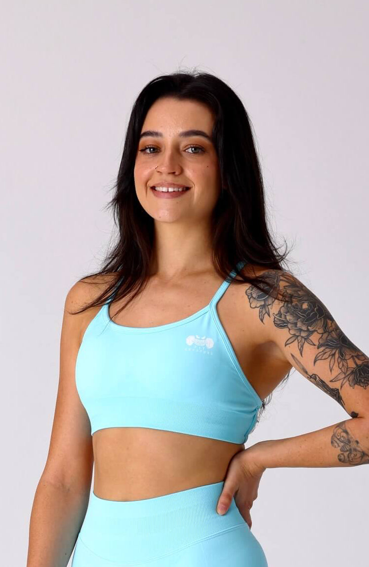 Woman wearing a light blue athletic outfit on a white background